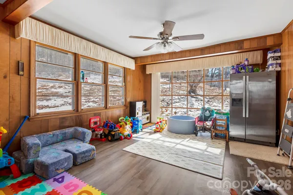 a living room with furniture and floor to ceiling window