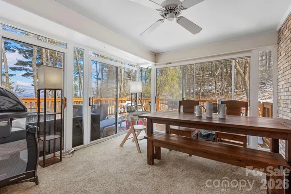 a view of a dining room with furniture and chandelier