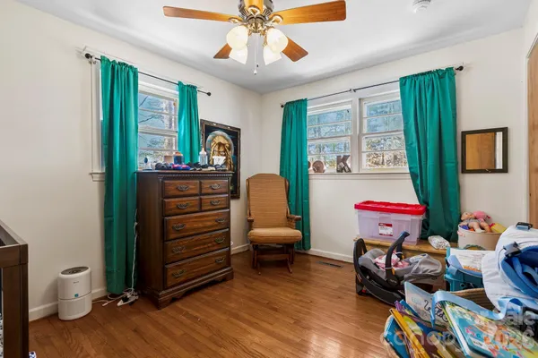 a bedroom with furniture and a window