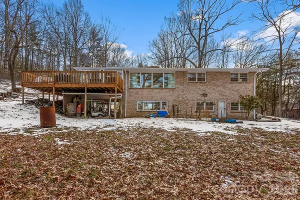 a front view of a house with a yard covered with snow