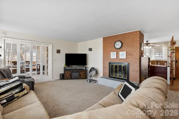 a living room with furniture a fireplace and a flat screen tv