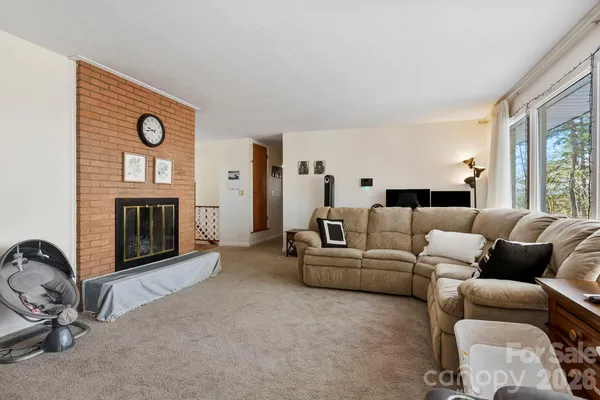 a living room with furniture a window and a fireplace