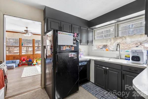 a kitchen with stainless steel appliances a refrigerator sink and cabinets