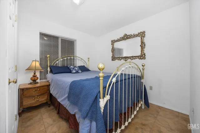 a bedroom with bed and a window