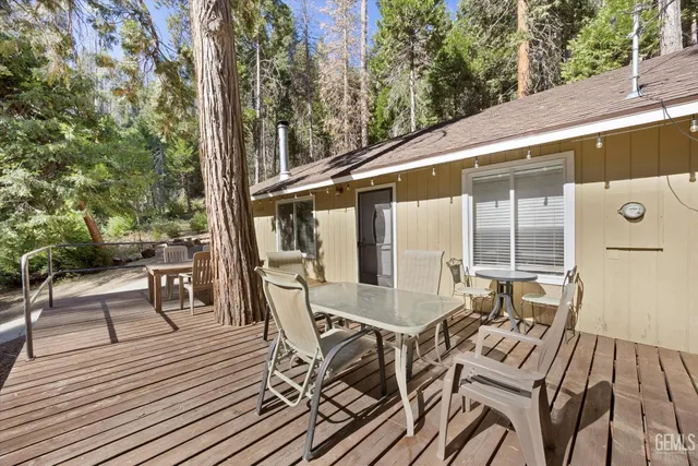 a view of deck with table and chairs and wooden floor
