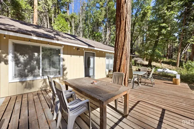 a view of a patio with table and chairs and wooden floor