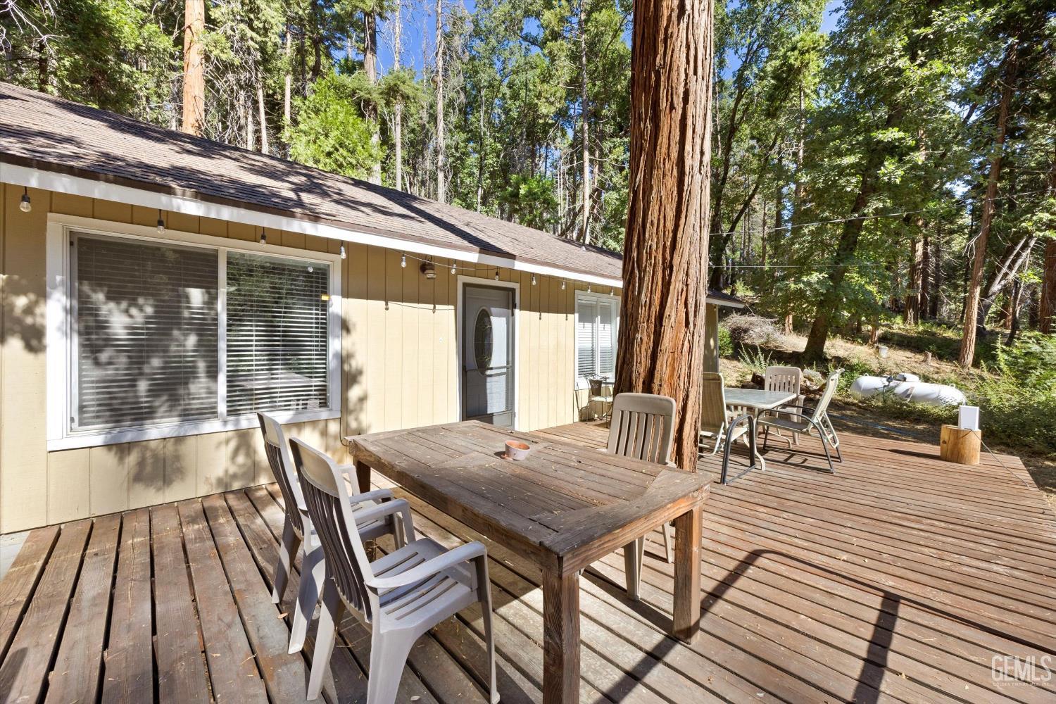 Undisclosed Address Posey, CA 93260 - Photo 21 of 28 a view of a patio with table and chairs and wooden floor