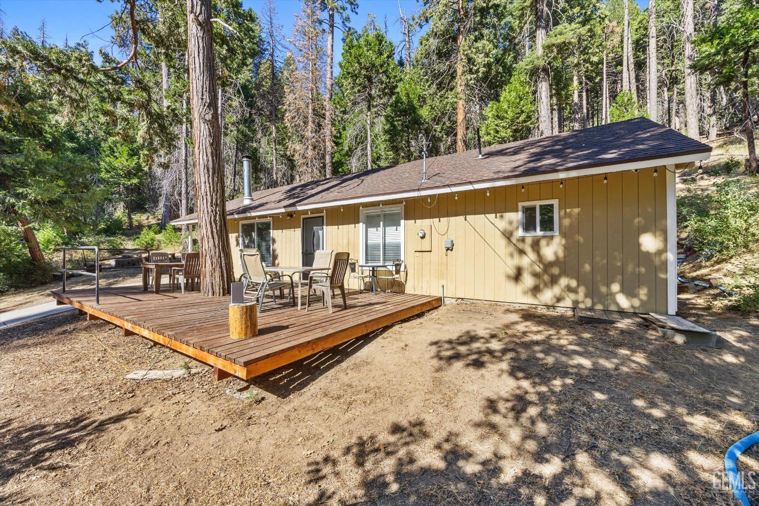 Undisclosed Address Posey, CA 93260 - Photo 4 of 28 a view of a backyard with a large tree