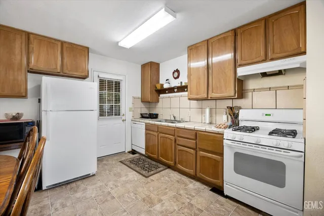 a kitchen with a sink stove and refrigerator