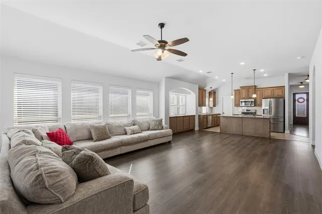 a living room with furniture and kitchen view