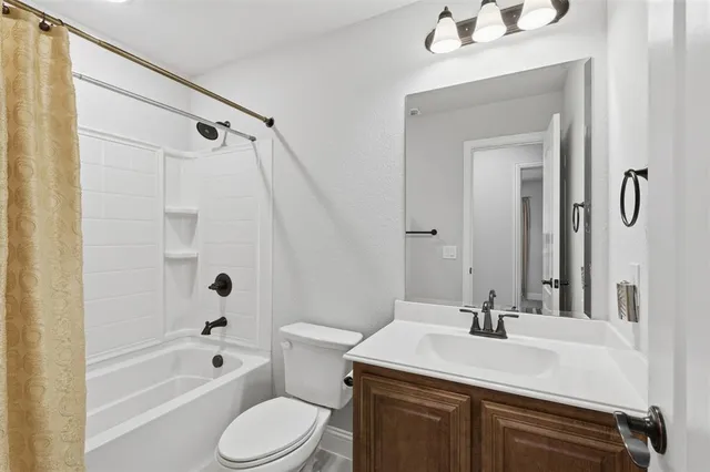 a bathroom with a sink toilet tub and shower
