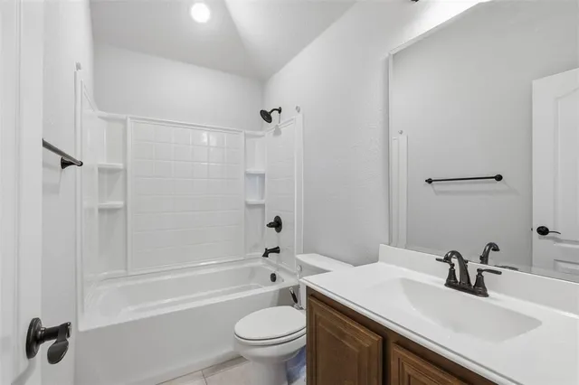 a bathroom with a sink toilet vanity and shower