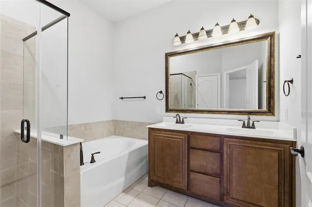 a bathroom with a tub sink and mirror