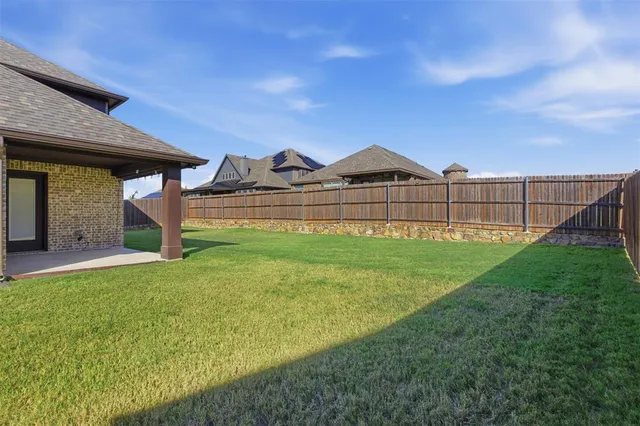 a view of a house with a big yard and large trees