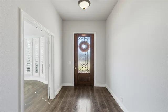 a view of an entryway with wooden floor