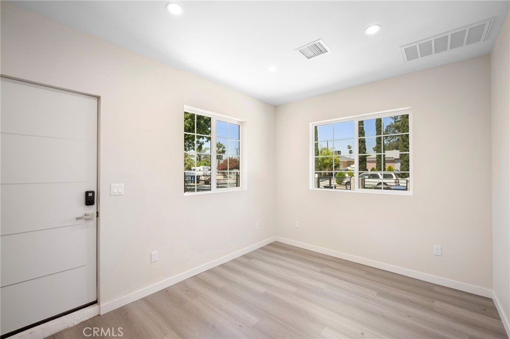 8435 Rincon Avenue Sun Valley, CA 91352 - Photo 27 of 61 an empty room with wooden floor and windows