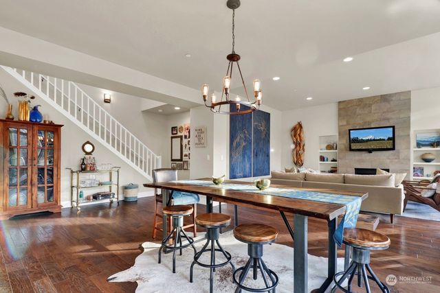 a room with stainless steel appliances kitchen island a table and chairs in it
