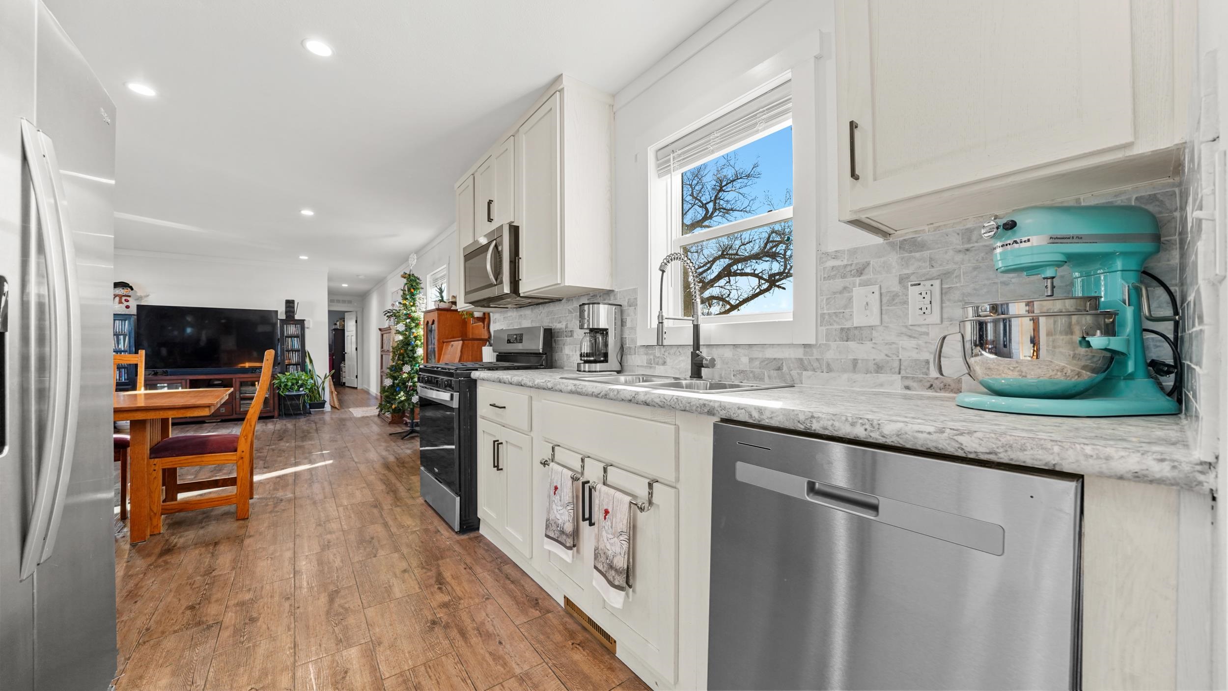 1296 M M 1/4 Road Loma, CO 81524 - Photo 12 of 30 a kitchen with stainless steel appliances granite countertop a sink a stove and a wooden floors