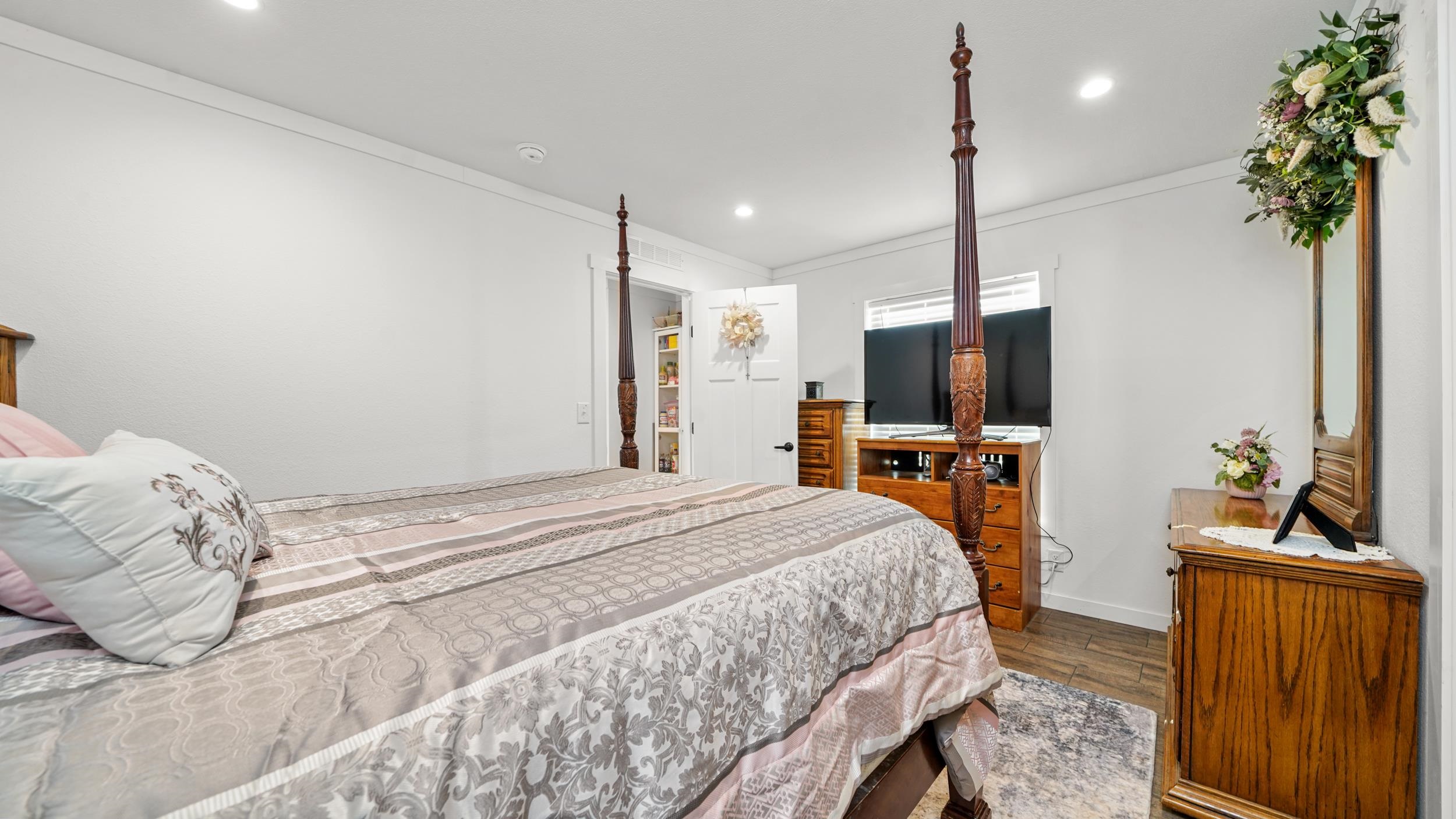 1296 M M 1/4 Road Loma, CO 81524 - Photo 14 of 30 a bedroom with a bed and a flat screen tv