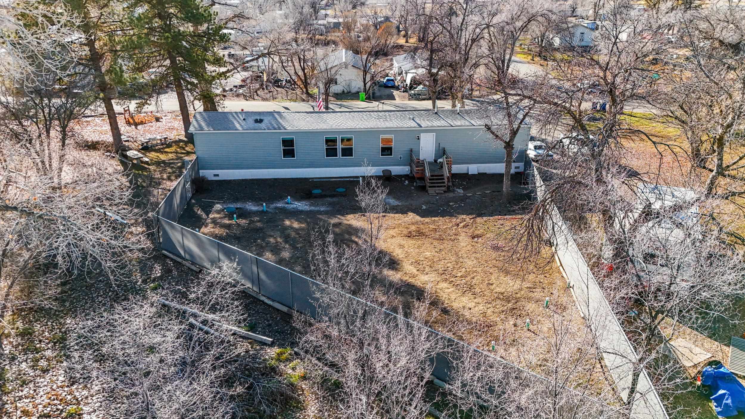 1296 M M 1/4 Road Loma, CO 81524 - Photo 25 of 30 a view of a house with a yard covered with snow
