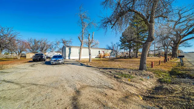a view of road with card parked on side and road
