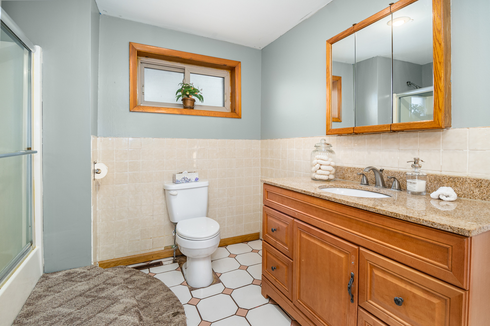 818 Clinton Street Lockport, IL 60441 - Photo 12 of 23 a bathroom with a granite countertop toilet sink and mirror
