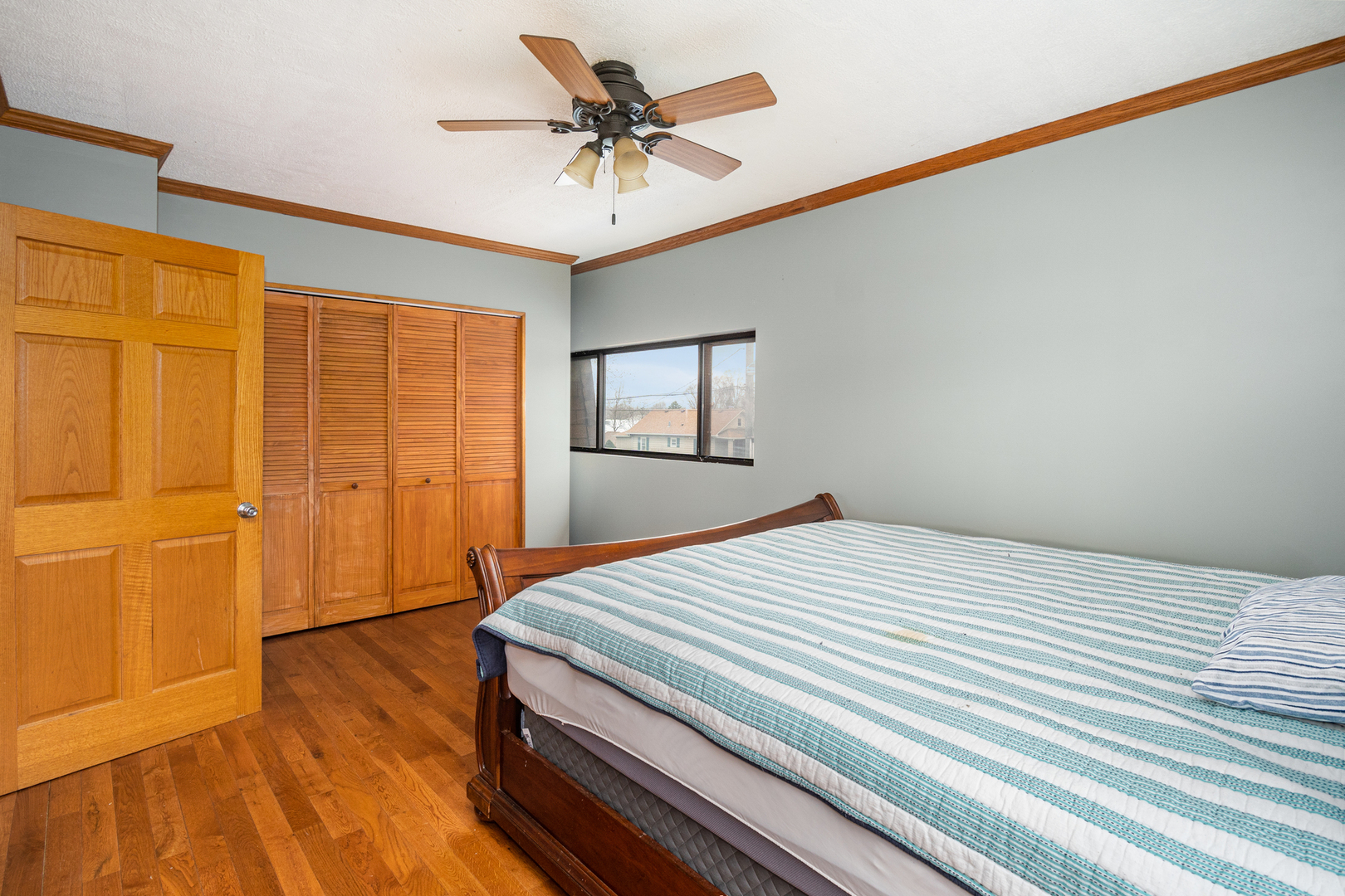 818 Clinton Street Lockport, IL 60441 - Photo 14 of 23 a bedroom with a bed and a chandelier