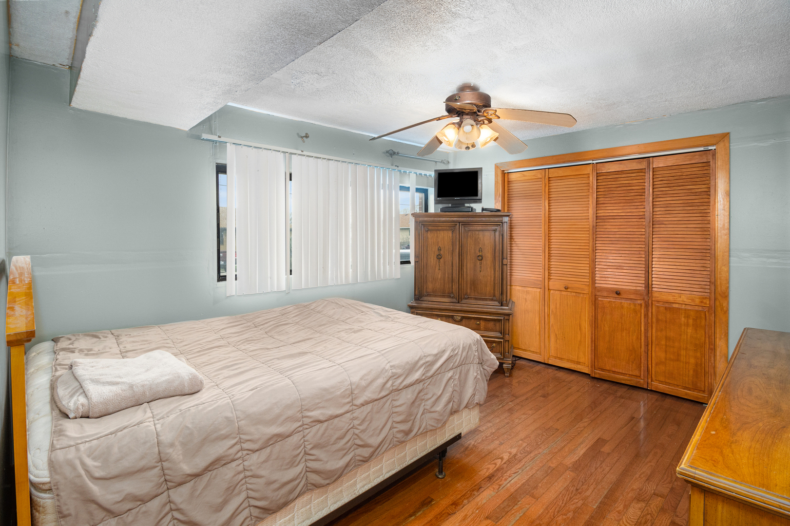 818 Clinton Street Lockport, IL 60441 - Photo 10 of 23 a bedroom with a bed and a chandelier