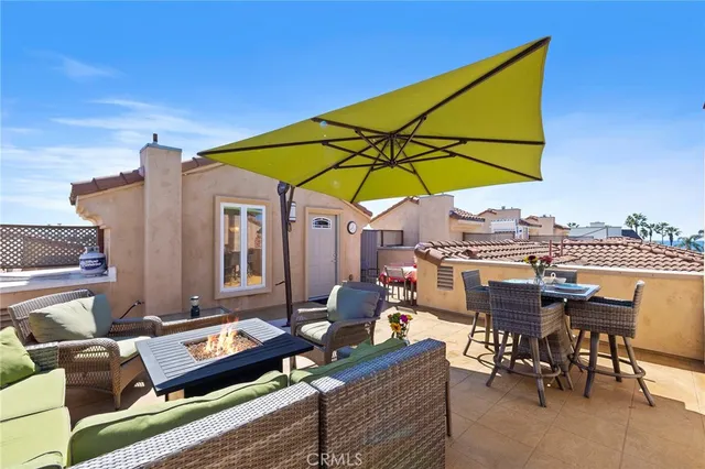 a kitchen with granite countertop a sink and dishwasher a refrigerator with wooden cabinets