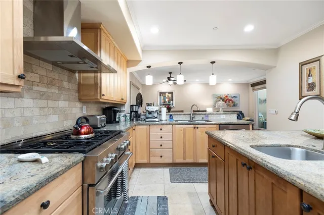 a kitchen with granite countertop a sink a counter space appliances and cabinets