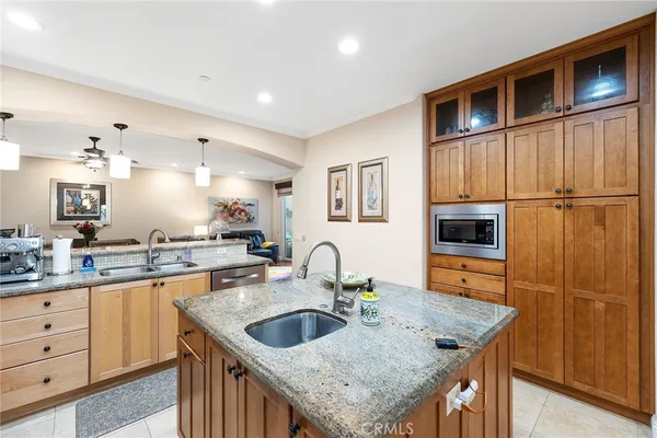 a kitchen with a refrigerator a sink and cabinets
