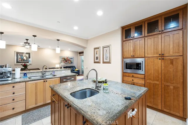 a kitchen with a refrigerator a sink and cabinets
