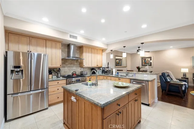 a living room with furniture and kitchen view