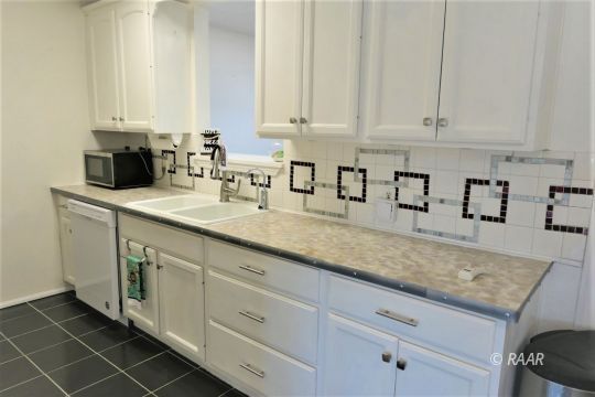 1263 Primrose Street Ridgecrest, CA 93555 - Photo 8 of 35 a kitchen with granite countertop white cabinets and sink