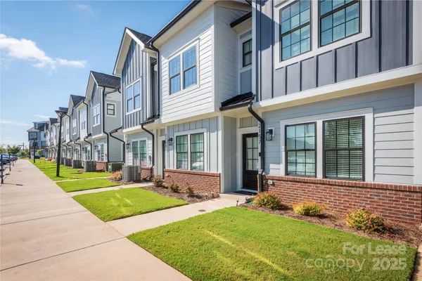 a view of a brick building next to a yard
