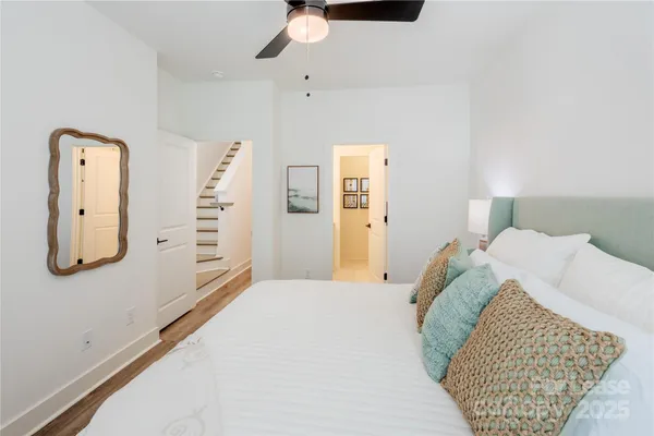 a bedroom with a bed and painting on the wall