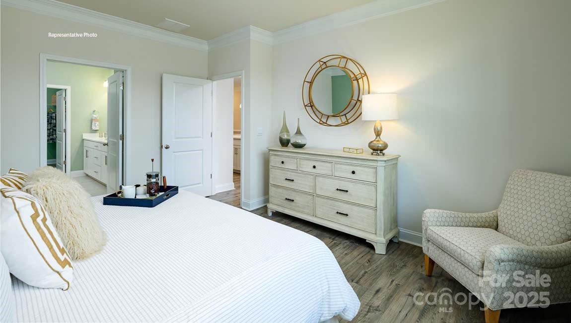 7641 Bainbridge Road Sherrills Ford, NC 28673 - Photo 15 of 29 a bedroom with a bed a mirror on dresser and a table