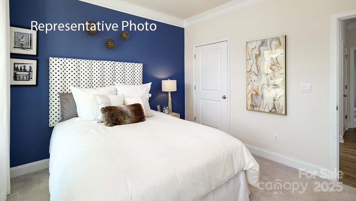 7641 Bainbridge Road Sherrills Ford, NC 28673 - Photo 22 of 29 a bed room with a bed and a painting on the wall