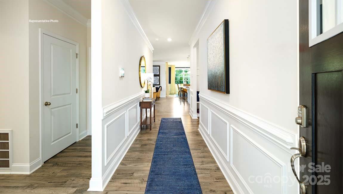7641 Bainbridge Road Sherrills Ford, NC 28673 - Photo 3 of 29 a view of a hallway with wooden floor and staircase