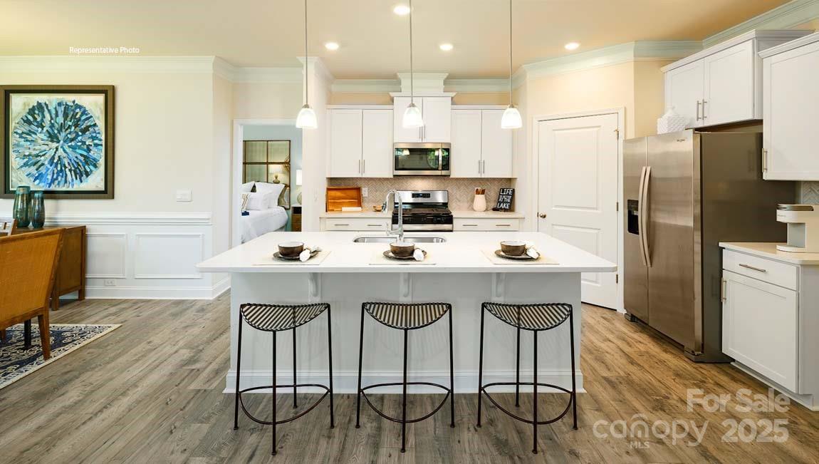 7641 Bainbridge Road Sherrills Ford, NC 28673 - Photo 5 of 29 a kitchen with stainless steel appliances kitchen island granite countertop a dining table chairs and a refrigerator