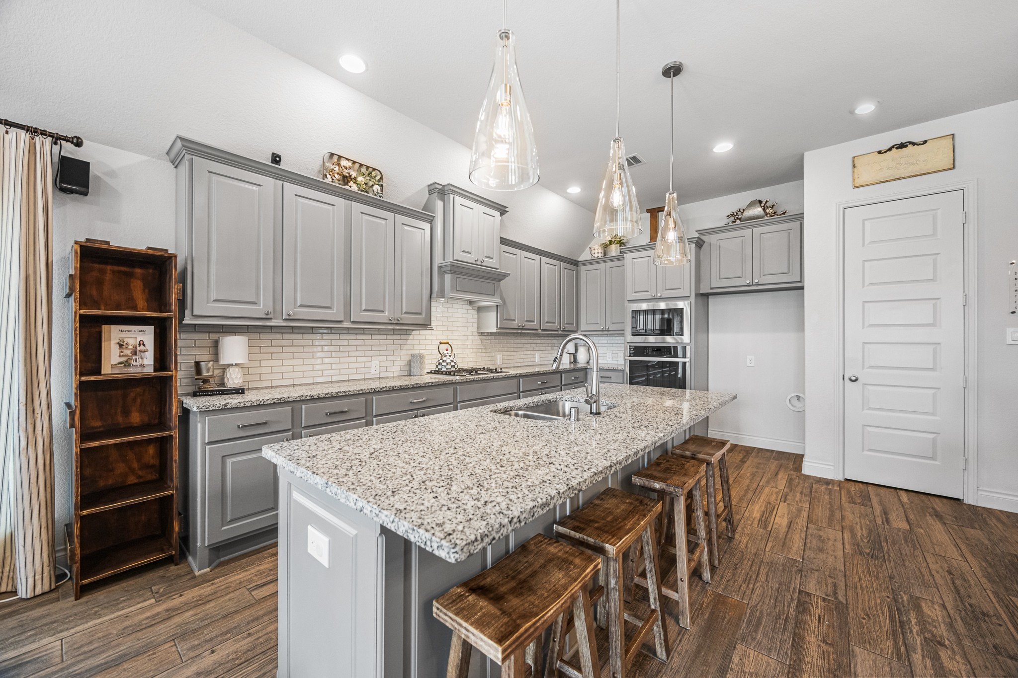 28169 Knight Peak Drive Spring, TX 77386 - Photo 7 of 33 a kitchen with cabinets and wooden floor