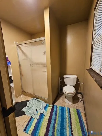 a bathroom with a toilet and a shower