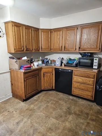a kitchen with granite countertop cabinets and window