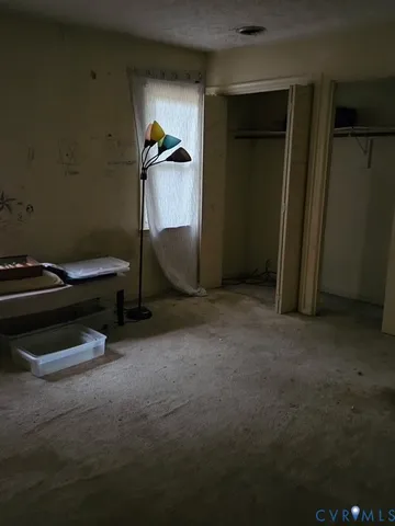 a living room with a chair and a fireplace