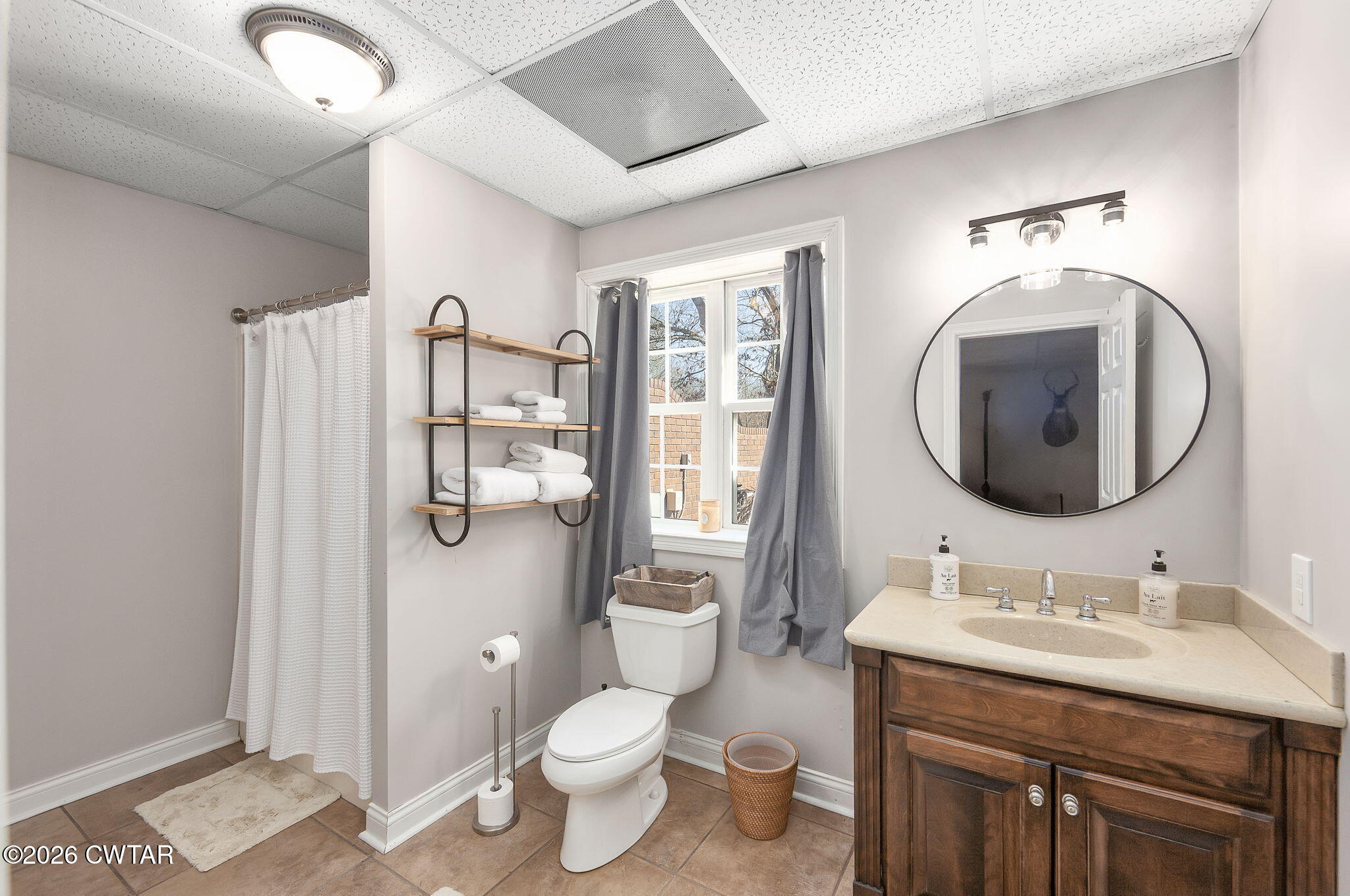 4320 Timberlake-Wildersville Road Lexington, TN 38351 - Photo 34 of 58 a bathroom with a granite countertop toilet a sink and a mirror