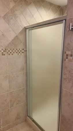 a bathroom with a glass shower door