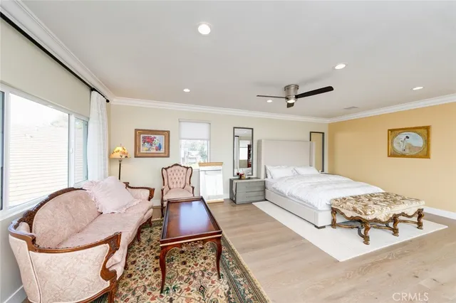 a spacious bedroom with a bed and a ceiling fan