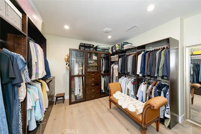 a view of room with workspace and wooden floor