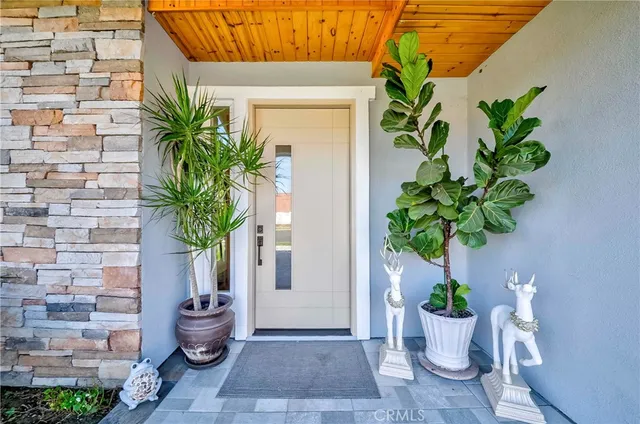 a living room with furniture potted plant and a chandelier