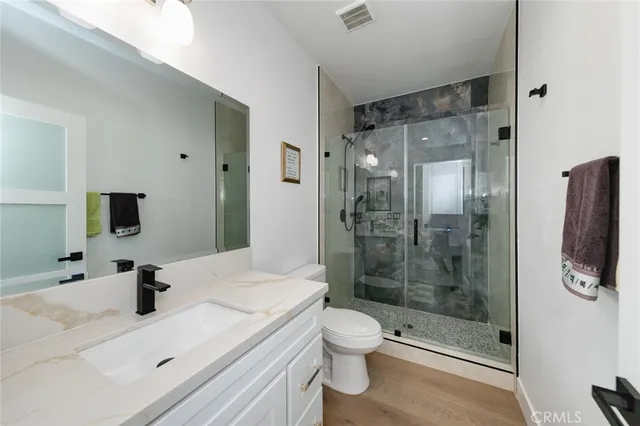 a view of a patio with a table chairs potted plants and a big yard